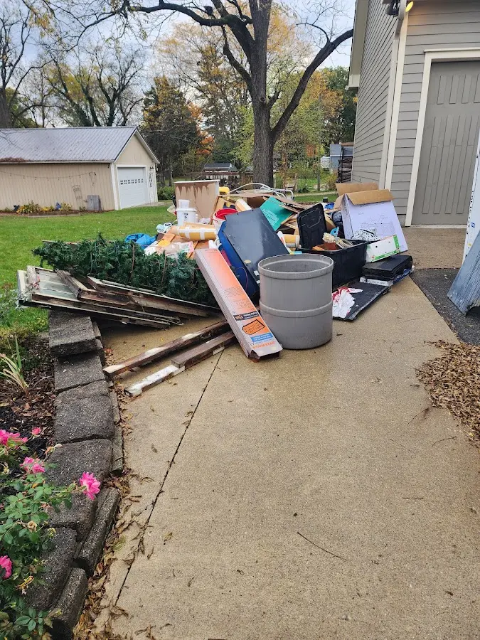 Dumpster being loaded with debris for Roofing Dumpster Rental in Fayetteville
